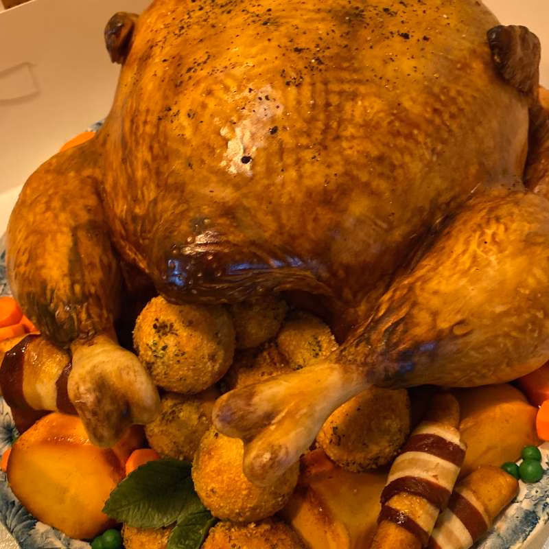 Close up detail showing pigs in blankets, stuffing balls, peas and carrots for bbc gone fishing illusion trukey cake