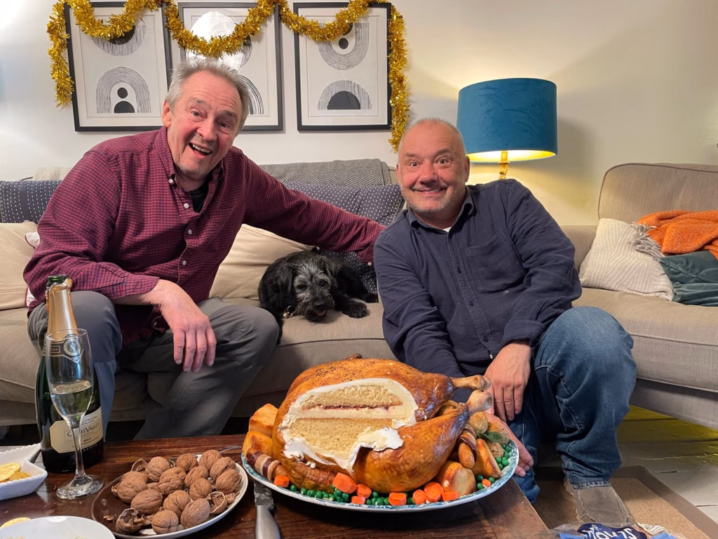 Paul Whitehouse & Bob Mortimer with the turkey illusion cake on set of the gone fishing 2025 christmas special