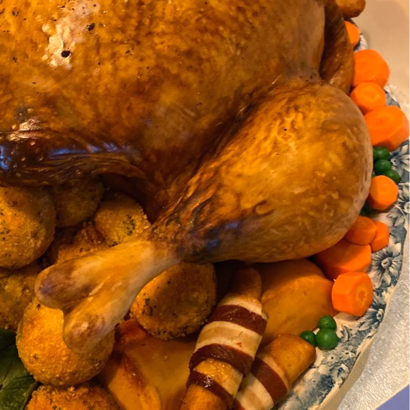 Close up detail showing pigs in blankets, stuffing balls, peas and carrots for bbc gone fishing illusion trukey cake