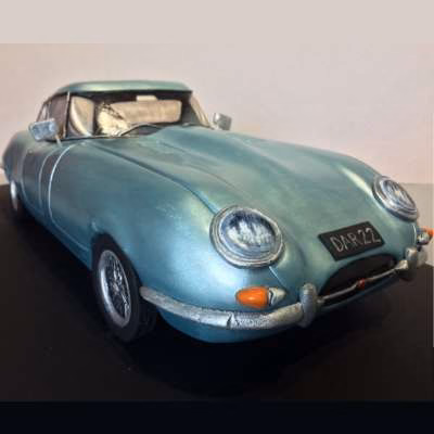 Hand carved E-type Jaguar cake. Lustre metalic paintwork and spoke wheel details