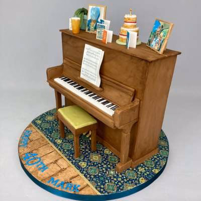Sculpted piano cake featuring edible card details and hand crafted cake